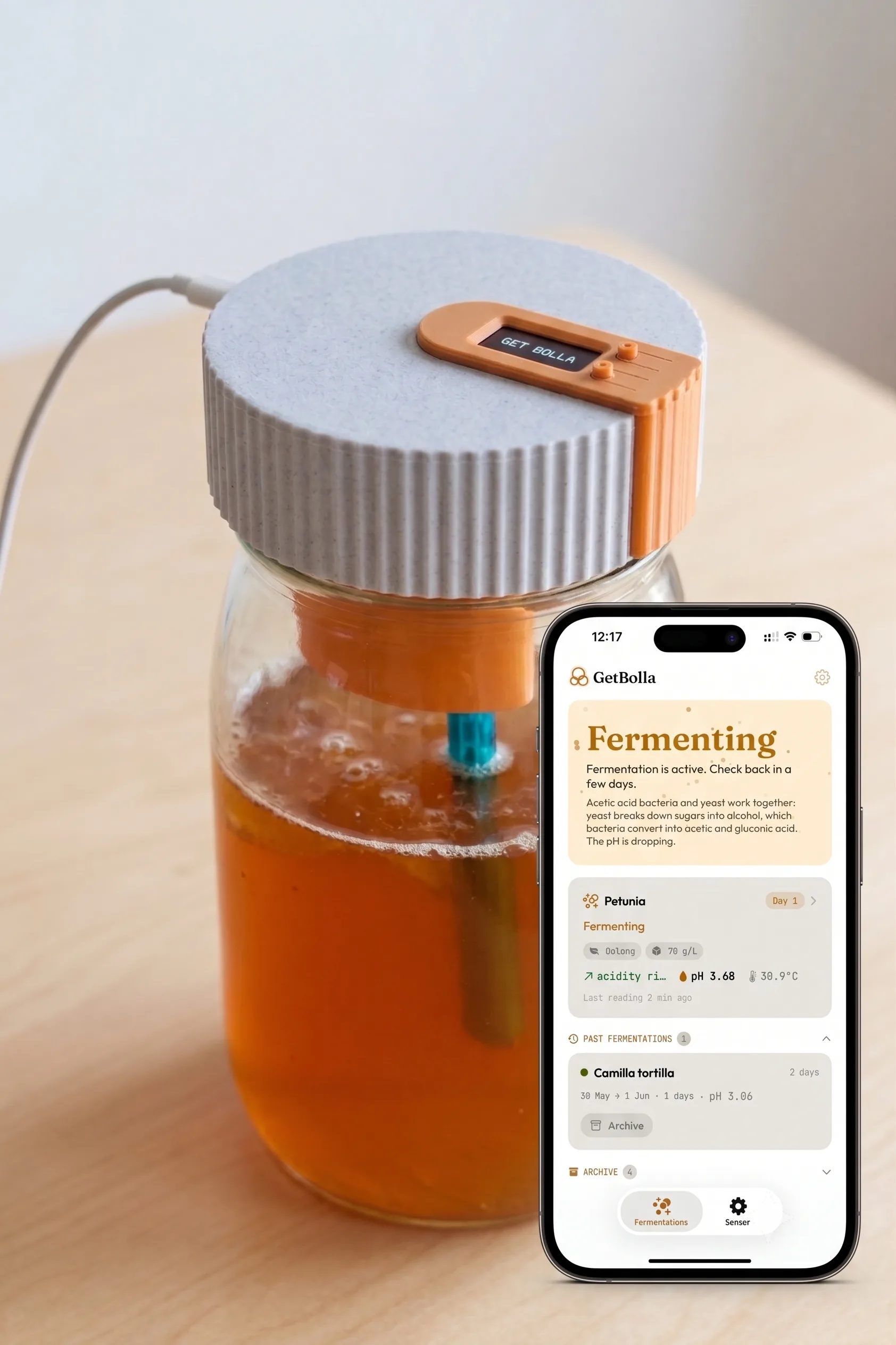 GetBolla sensor submerged in a kombucha jar on a kitchen counter